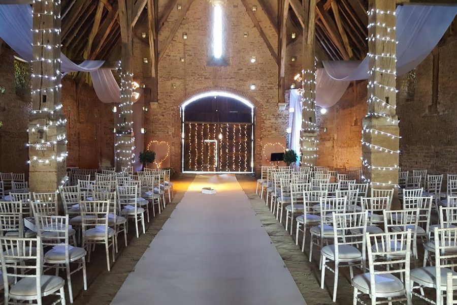 Limewash Chiavari chairs laid out for a barn wedding