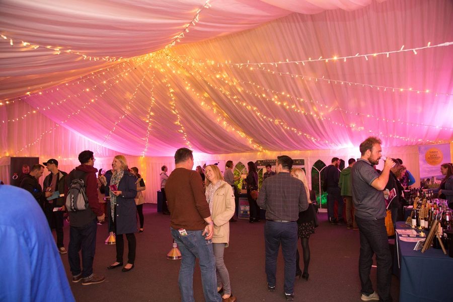 Warm fairy lights hung below a pleated marquee lining
